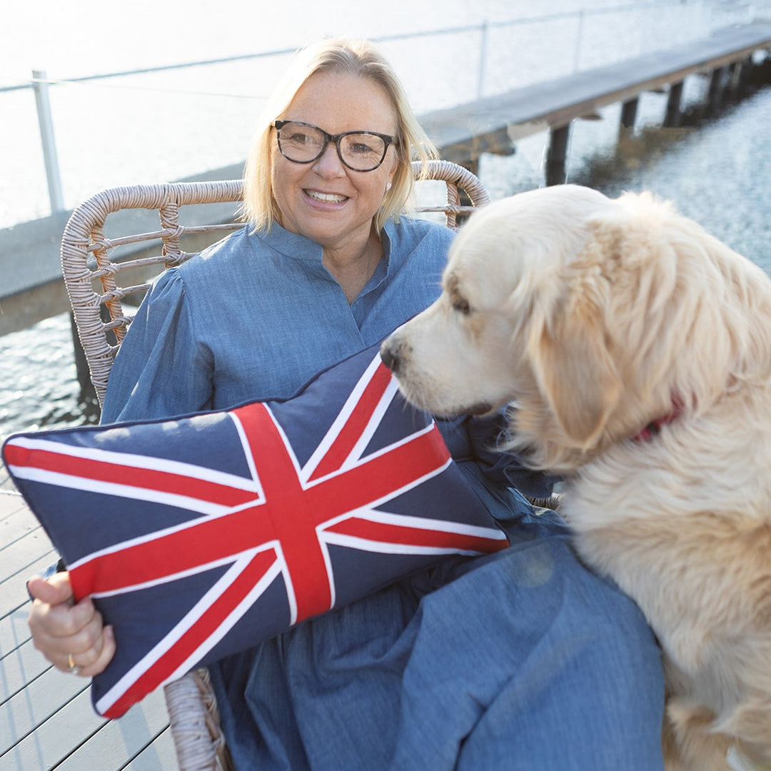Jane Fonti from Ruby's Home Store with her dog Toby, holding the Union Jack cushion