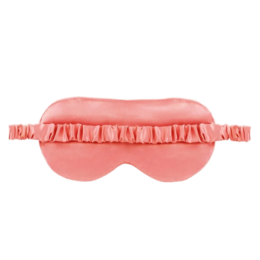 A pink satin sleep mask with a matching ruffled elastic band, shown against a plain white background.