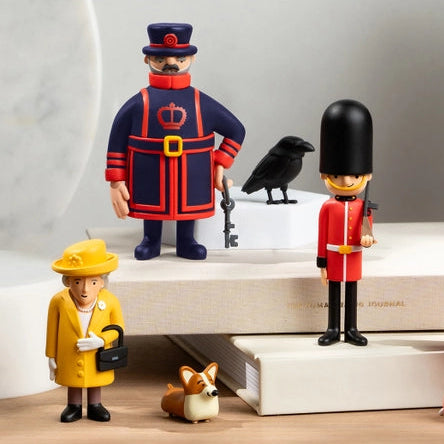 Collection of toy figurines on a wooden surface with a plant in the background