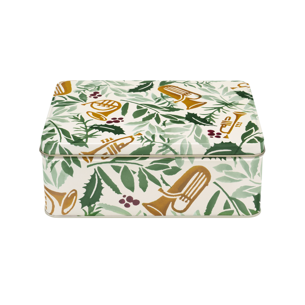 A rectangular metal tin with a hinged lid, decorated with a pattern of green leaves and gold brass instruments on an off-white background.