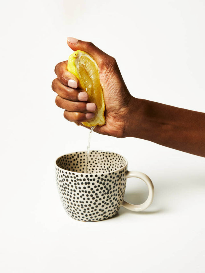 Chino mug in black sprinkle with lemon being squeezed. From Jones and Co at Ruby's Home Store