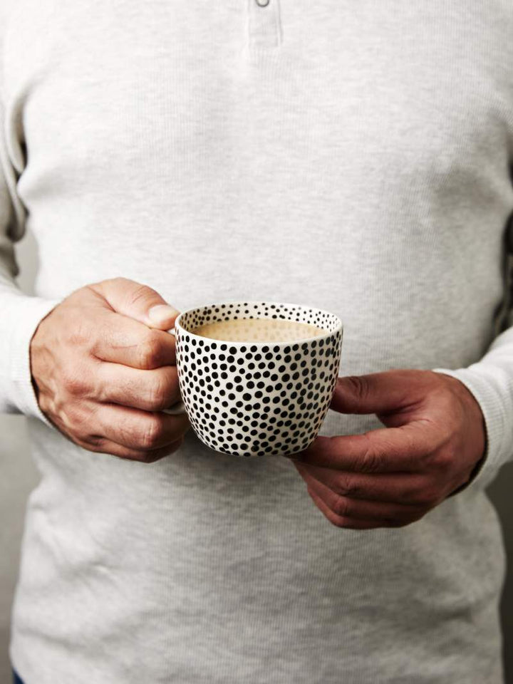 Man holding chino black sprinkle mug. From Jones and Co at Rubys Home Store