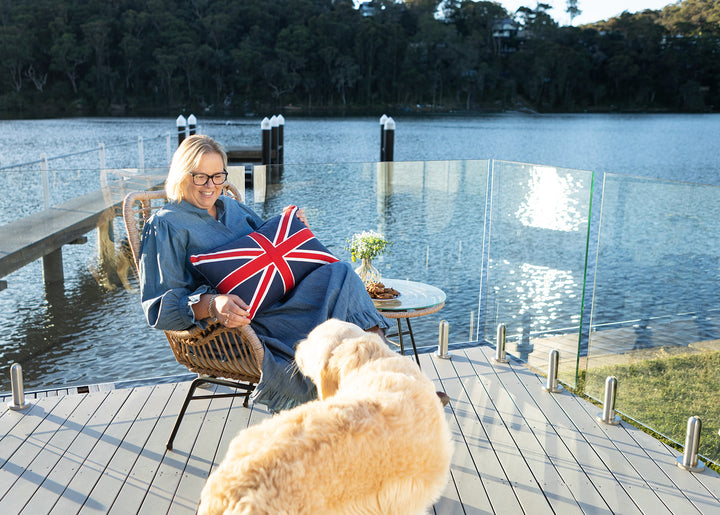 Jane Fonti from Ruby's Home Store, Woy Woy NSW, holding Union Jack cushion