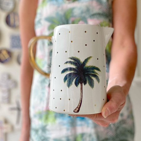 Medium white jug with palm tree, gold polka dots and gold handle.